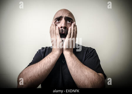 desperate bearded man isolated on gray background Stock Photo