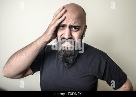 desperate bearded man isolated on gray background Stock Photo