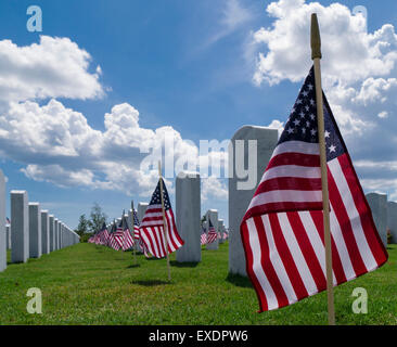 Rows of grave stones and American flags in Sarasota National Cemetery in Sarasota Florida Stock Photo