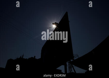 Gaza City, The Gaza Strip, Palestine. 12th July, 2015. Palestinian worker hang banner congratulates Gazans by Eid al-Fitr at Gaza City. © Mahmoud Issa/Quds Net News/ZUMAPRESS.com/Alamy Live News Stock Photo