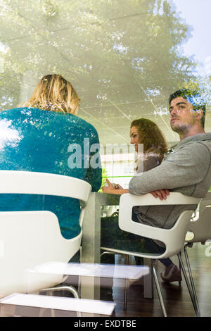 Three business colleagues communicating during break Stock Photo