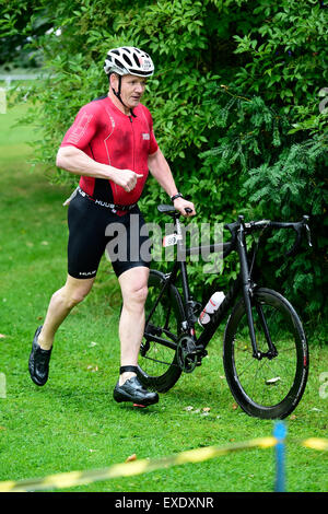 Markeaton Park, Derby, UK. 12th July 2015. Gordon Ramsey exiting the bike transition at the Jenson Button Trust Triathlon in Markeaton Park, Derby, UK. 12th July 2015 Credit:  Steve Tucker/Alamy Live News Stock Photo