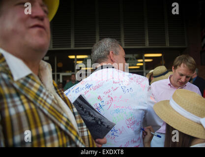 Elmont, New York, USA. 7th June, 2015. Woman writes wishes on the man's jacket during celebration of winning Victor Espinoza with American Pharoah #5 in the 147th running of the Belmont Stakes at Belmont Park. With the win American Pharoah becomes the first horse to win the Triple Crown in 37 years. © Anna Sergeeva/ZUMA Wire/Alamy Live News Stock Photo