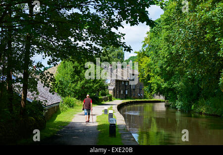 Man walking on towpath of the Rochdale Canal at Brearley, near Sowerby Bridge, West Yorkshire, England UK Stock Photo