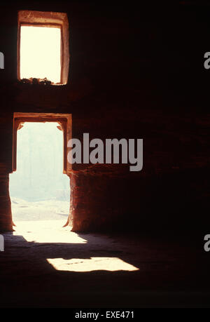 Light shines through an opening of the Urn Tomb in Petra, Jordan Stock Photo