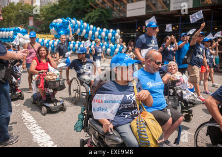 New York, USA. 12th July, 2015. People with disabilities and their supporters march down Broadway from Madison Square Park in New York for the First Annual Disability Pride Parade on Sunday, July 12, 2015 celebrating the 25th anniversary of the signing of the Americans With Disabilities Act (ADA).  The ADA ensured accessibility to the disabled and removed barriers to employment, transportation, public accommodations, public services and telecommunications. Credit:  Richard Levine/Alamy Live News Stock Photo