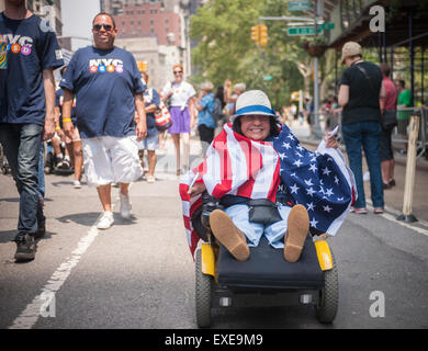 New York, USA. 12th July, 2015. People with disabilities and their supporters march down Broadway from Madison Square Park in New York for the First Annual Disability Pride Parade on Sunday, July 12, 2015 celebrating the 25th anniversary of the signing of the Americans With Disabilities Act (ADA).  The ADA ensured accessibility to the disabled and removed barriers to employment, transportation, public accommodations, public services and telecommunications. Credit:  Richard Levine/Alamy Live News Stock Photo