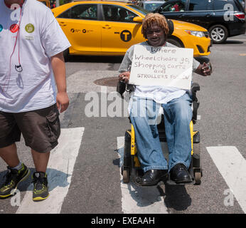 New York, USA. 12th July, 2015. People with disabilities and their supporters march down Broadway from Madison Square Park in New York for the First Annual Disability Pride Parade on Sunday, July 12, 2015 celebrating the 25th anniversary of the signing of the Americans With Disabilities Act (ADA).  The ADA ensured accessibility to the disabled and removed barriers to employment, transportation, public accommodations, public services and telecommunications. Credit:  Richard Levine/Alamy Live News Stock Photo