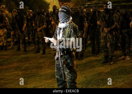 Gaza, Palestine. 12th July, 2015. Militants from al-Nasser Salah al-Deen Brigade, the military wing of the Popular Resistance Committees march during an anti-Israel rally marking the first anniversary of the 50-day Israeli war on Gaza Strip last summer. © Nidal Alwaheidi/Pacific Press/Alamy Live News Stock Photo