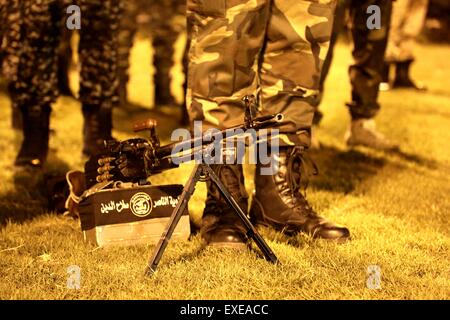 Gaza, Palestine. 12th July, 2015. Militants from al-Nasser Salah al-Deen Brigade, the military wing of the Popular Resistance Committees march during an anti-Israel rally marking the first anniversary of the 50-day Israeli war on Gaza Strip last summer. © Nidal Alwaheidi/Pacific Press/Alamy Live News Stock Photo