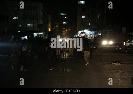 Gaza, Palestine. 12th July, 2015. Militants from al-Nasser Salah al-Deen Brigade, the military wing of the Popular Resistance Committees march during an anti-Israel rally marking the first anniversary of the 50-day Israeli war on Gaza Strip last summer. © Nidal Alwaheidi/Pacific Press/Alamy Live News Stock Photo