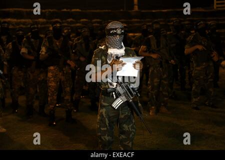 Gaza, Palestine. 12th July, 2015. Militants from al-Nasser Salah al-Deen Brigade, the military wing of the Popular Resistance Committees march during an anti-Israel rally marking the first anniversary of the 50-day Israeli war on Gaza Strip last summer. © Nidal Alwaheidi/Pacific Press/Alamy Live News Stock Photo