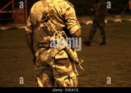 Gaza, Palestine. 12th July, 2015. Militants from al-Nasser Salah al-Deen Brigade, the military wing of the Popular Resistance Committees march during an anti-Israel rally marking the first anniversary of the 50-day Israeli war on Gaza Strip last summer. © Nidal Alwaheidi/Pacific Press/Alamy Live News Stock Photo