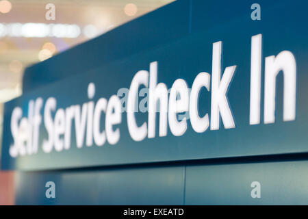 self service check in sign at airport Stock Photo
