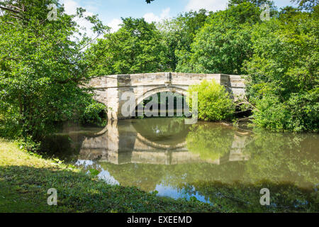 A substantially built stone three arch bridge carrying a road over the River Rye in Nunnington North Yorkshire Stock Photo