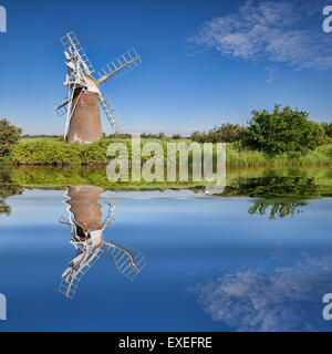 Turf Fen Winmill reflecting in the smooth waters of the Norfolk Broads, Norfolk, England Stock Photo