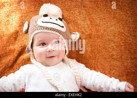 Baby in monkey hat Stock Photo