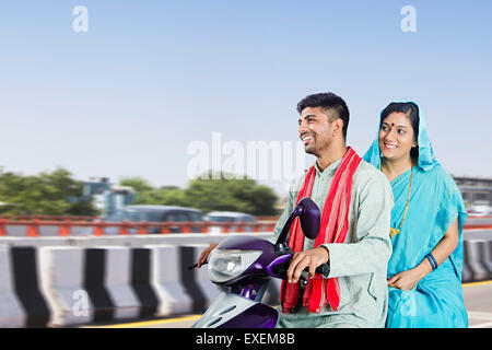 2 indian Rural Married Couple Highway road Riding Scooty Stock Photo