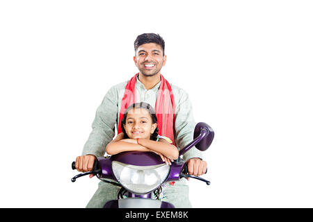 2 indian Rural  father with Daughter Riding Scooty Stock Photo