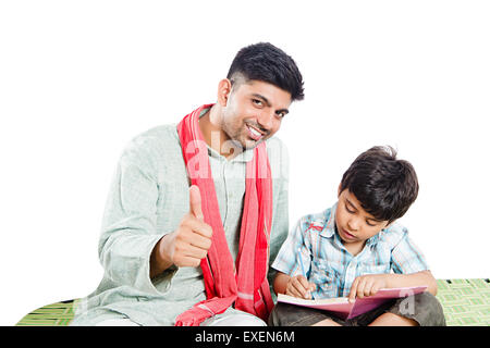 2 indian Rural father Teaching son and Thumbs Up showing Stock Photo