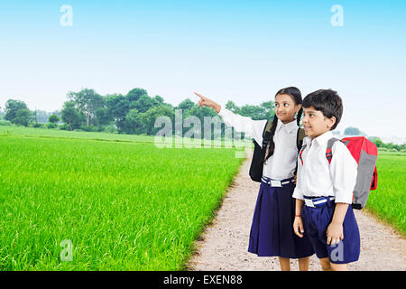 2 indian rural School kids friends farm finger pointing Stock Photo