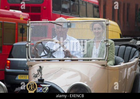 Wimbledon London,UK. 13th July 2015. Drivers in an open top vintage car are hit by persistent rain drizzle as they drive through Wimbledon town centre Credit:  amer ghazzal/Alamy Live News Stock Photo