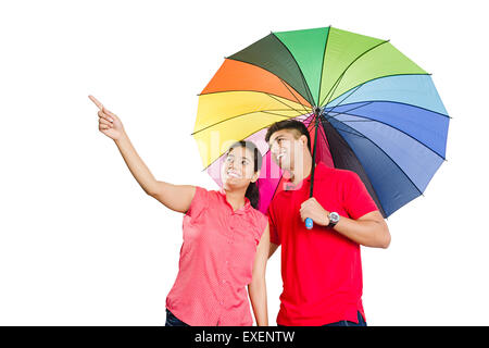 2 indian Married Couple  Umbrella Rain Protection finger pointing Stock Photo