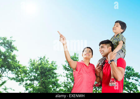 indian Parents with son park enjoy finger pointing Stock Photo