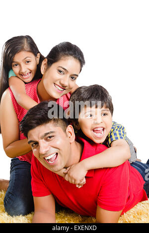 indian Parents with kids Lying Down fun Stock Photo