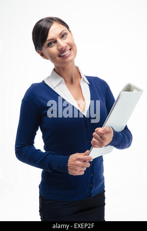 Smiling businesswoman holding folder over white background and looking at camera Stock Photo