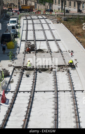 Men working on new tram tracks within Montpellier,  Hérault , Languedoc-Roussillon, France, Europe Stock Photo