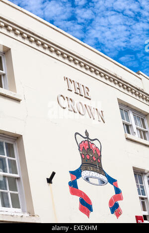 The Crown painted sign on side of 16th century coaching inn building at Emsworth, Hampshire, UK in July Stock Photo