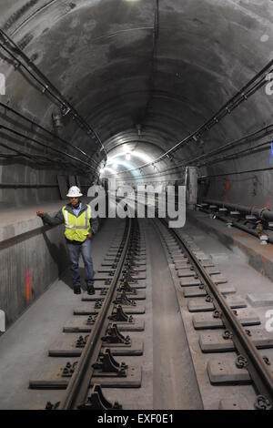 A construction worker walks through the new underground line tunnel at 70th street in Manhattan, New York, USA, 21 May 2015. The new Second-Avenue Line is the first subway line under construction for the past 70 years. The project amounst to around 17 billion dollars making it the most expensive subway line in the world. Construction costs run up to an estimated 4,1 billion dollars for the first stage of construction which is expected to be concluded by December 2016. Photo: Chris Melzer/dpa Stock Photo