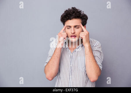 Portrait of a young handsome man thinking over gray background Stock Photo