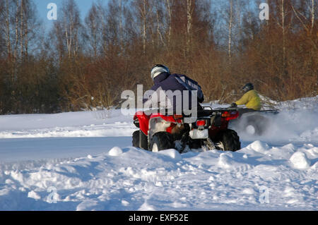 all terrain vehicle in motion at winter Stock Photo