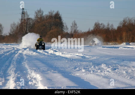 all terrain vehicle in motion at winter Stock Photo