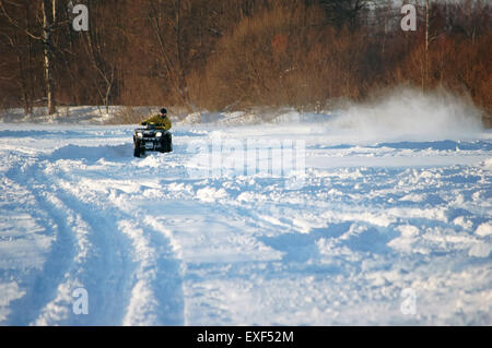 A men in protective sportswear riding snowmobile Branas Ski Resort