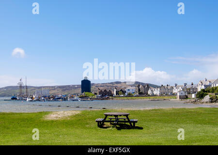 View across Leodamais Bay to moored boats in harbour from seafront in Port Ellen, Isle of Islay, Inner Hebrides, Scotland, UK Stock Photo