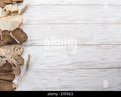 Different types of sliced bread on wooden background. Stock Photo
