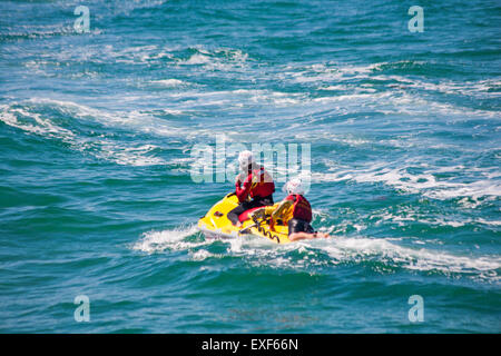 RNLI Lifeguards jetski with lifeguards on patrol at sea in Bournemouth, Dorset UK in June Stock Photo