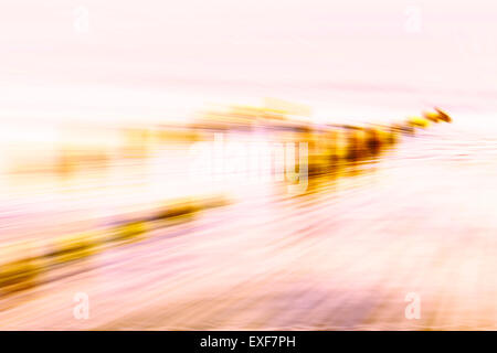 Motion blurred abstract background, wooden posts on beach. Stock Photo
