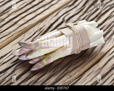 Shoots of white asparagus on the old wooden table. Stock Photo