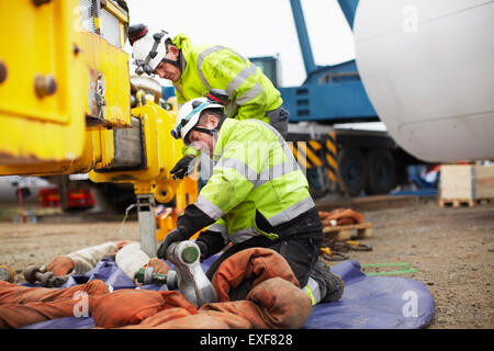 Engineers preparing to work on wind turbine Stock Photo