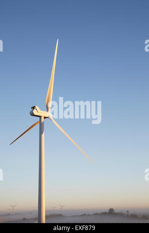 Wind turbine against blue sky Stock Photo
