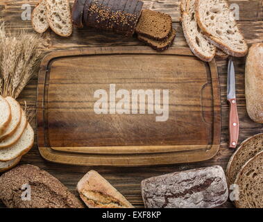Sliced black bread on the old wooden plank. Stock Photo