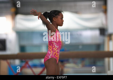 Young gymnast girl stretching and training Stock Photo