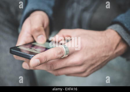 Close up of businessman hands texting on smartphone Stock Photo