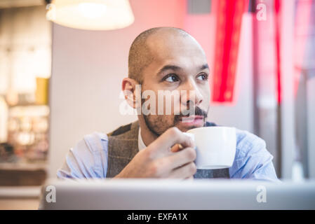 Businessman sitting in cafe drinking coffee Stock Photo