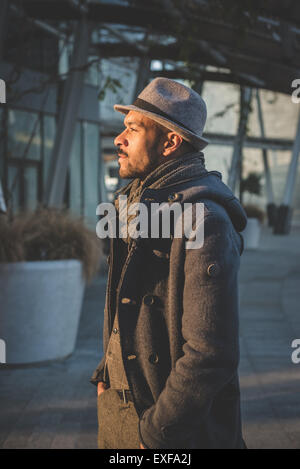 Businessman standing waiting outside office building Stock Photo