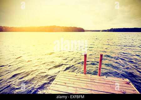 Vintage instagram filtered wooden pier at sunset.